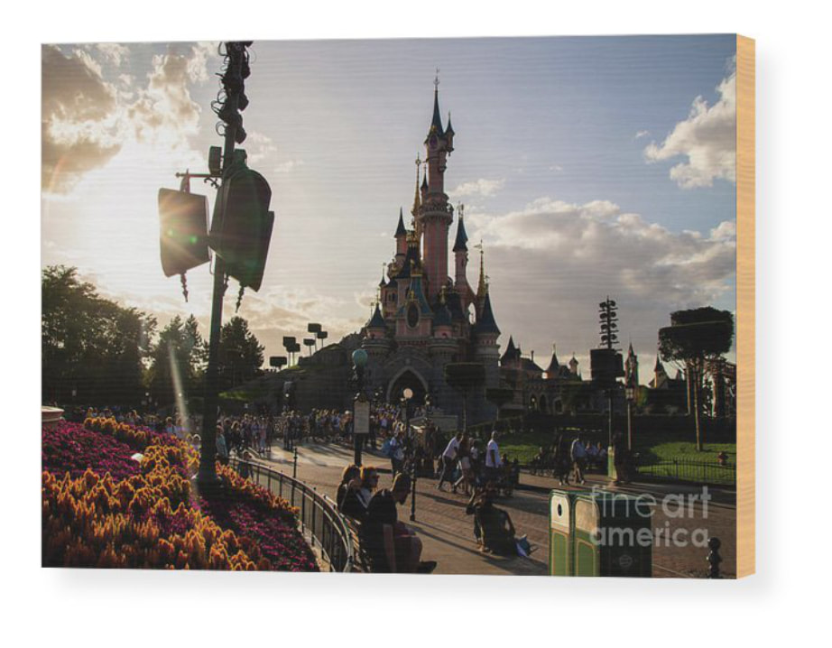 Captivating wood print of "Enchanted Sunset: Sleeping Beauty's Castle" at Disneyland Paris on Fine Art America, showcasing the magical beauty and nostalgic charm. Illuminate your space with the warmth and wonder of this iconic fairy tale castle.